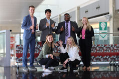 A group of students posing in the Health & Human Sciences building.